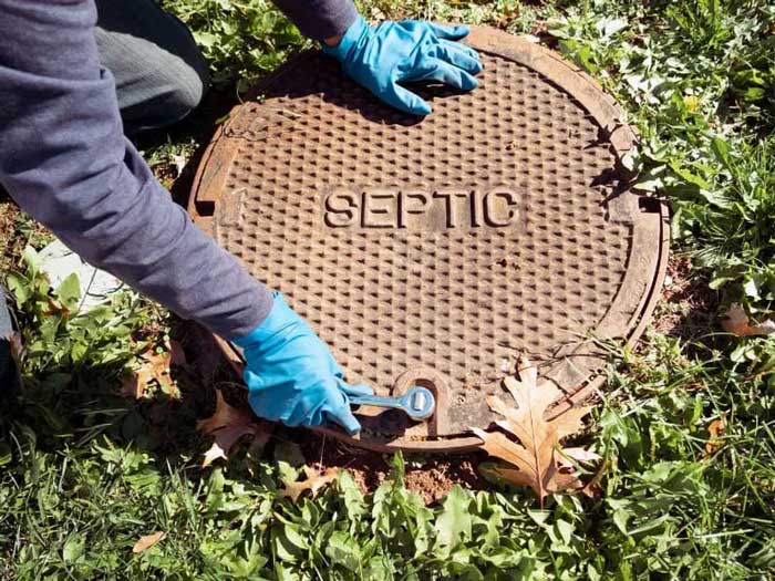 Worker performing a septic tank inspection in NY and NJ